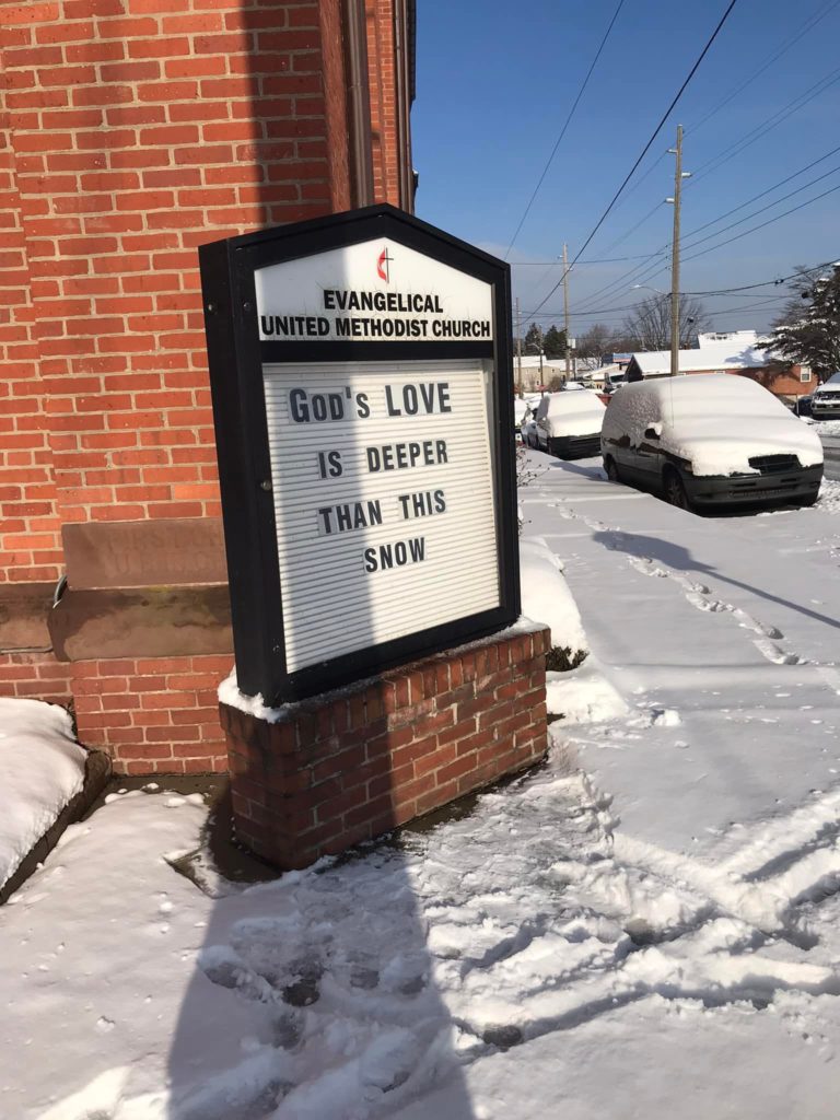 church sign saying "God's love is deeper than this snow."