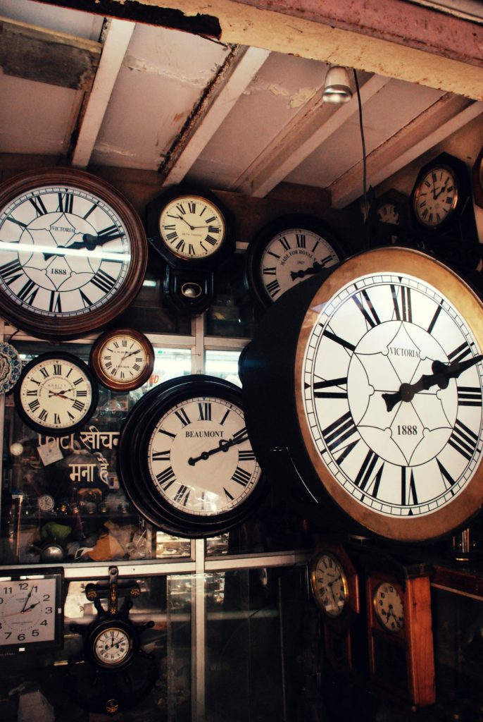 various analog clocks in various positions and depths