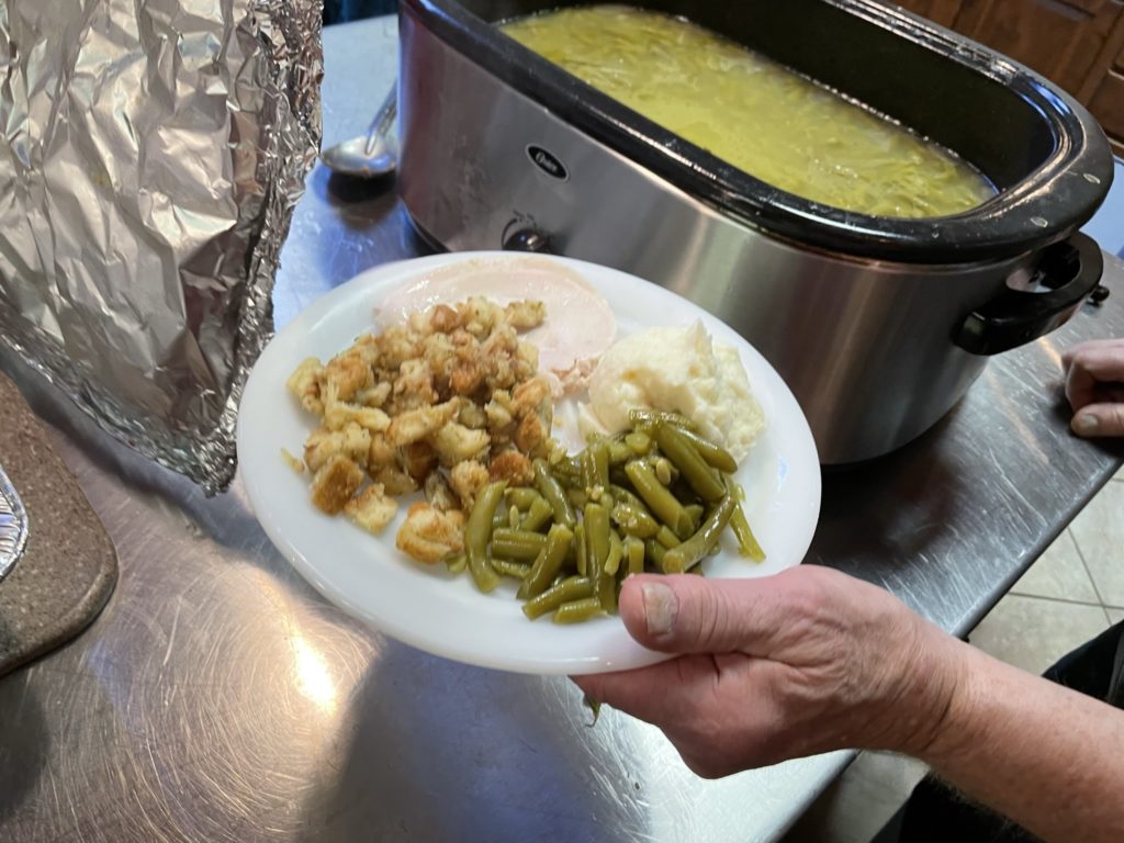 plate of: turkey, stuffing, mashed potatoes, green beans