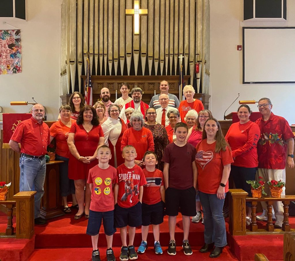 worshippers at front of sanctuary wearing read for Pentecost