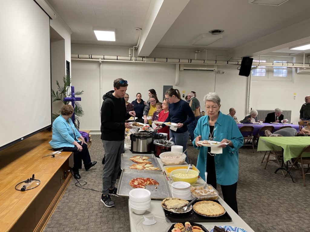 Folks getting food at our April potluck
