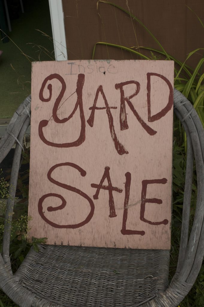 painted wooden sign with the words "inside yard sale"