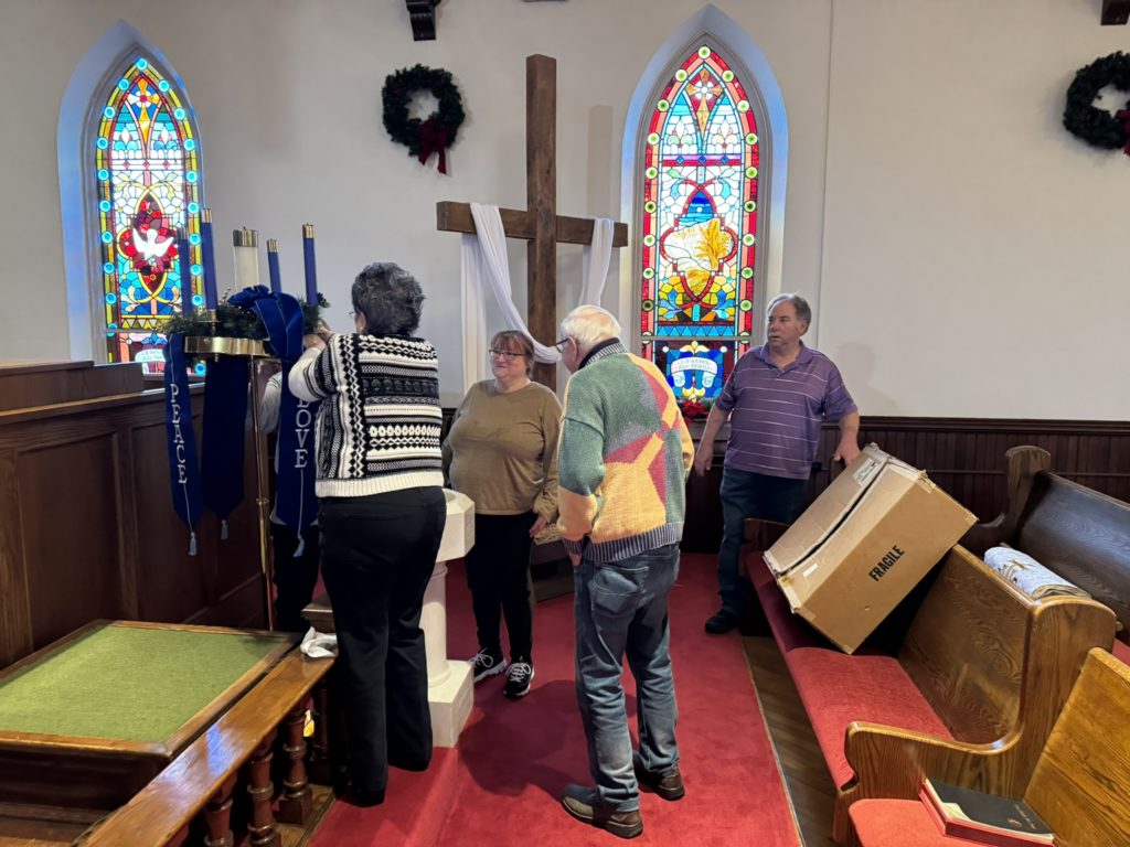 church members decorating sanctuary and setting up advent wreath