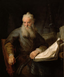 Rembrandt's Paul-old man sitting in front of a book with pen in hand.